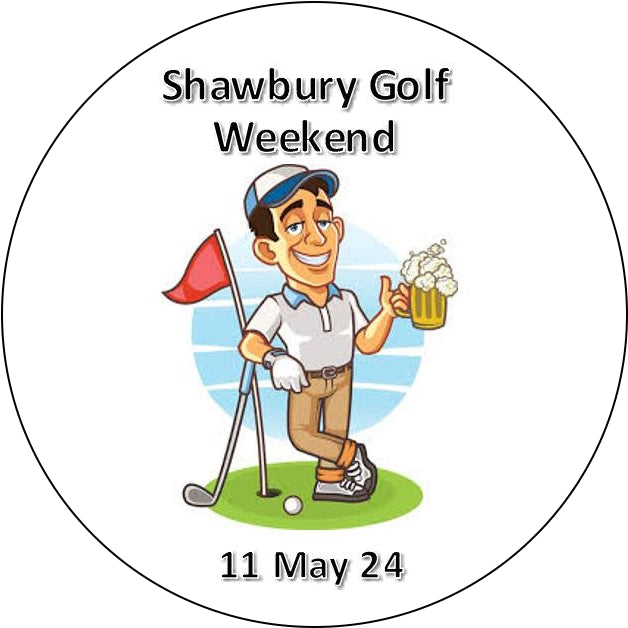 A circular printed graphic with the text 'Shawbury Golf Weekend' at the top and '11 May 24' at the bottom, featuring a cartoon golf player holding a beer on a green golf course background.